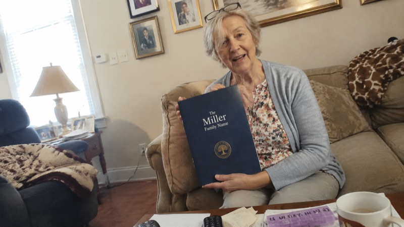 Margaret Miller reading her printed report at home