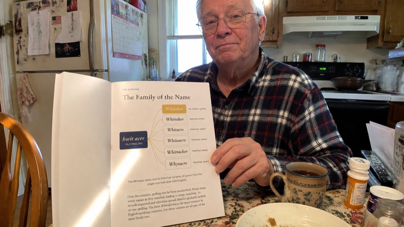 Earl Whitaker holding his printed report in the kitchen